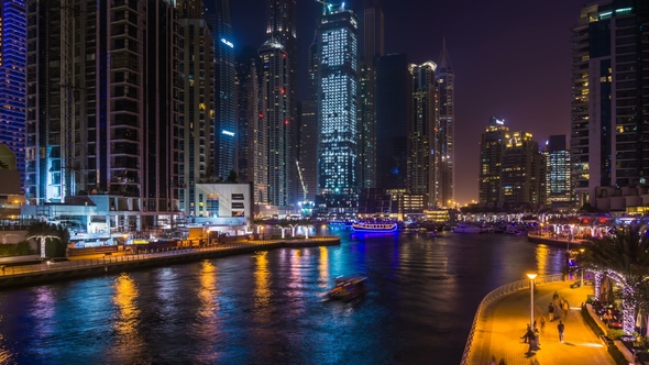 Beautiful View of the Skyscrapers of Dubai Marina with Bright Night Illumination and a Water Canal
