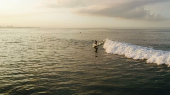 Surfing: Surfer Man Riding on the Blue Waves