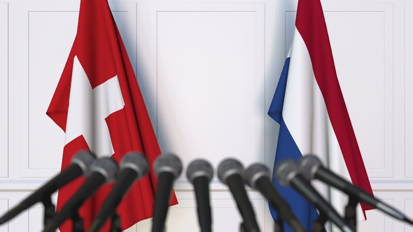 Flags of Switzerland and Netherlands at International Press Conference alt