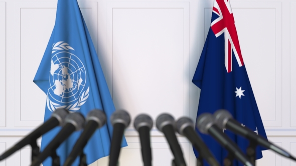 Flags of the United Nations and Australia at International Press Conference alt