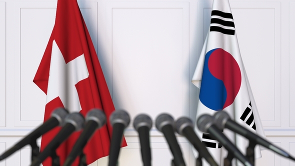 Flags of Switzerland and Korea at International Press Conference alt