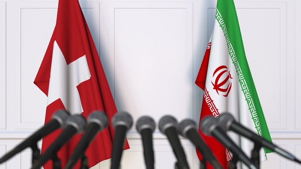 Flags of Switzerland and Iran at International Press Conference alt