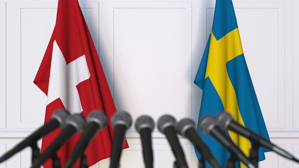 Flags of Switzerland and Sweden at International Press Conference alt