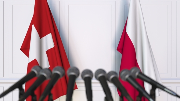 Flags of Switzerland and Poland at International Press Conference alt