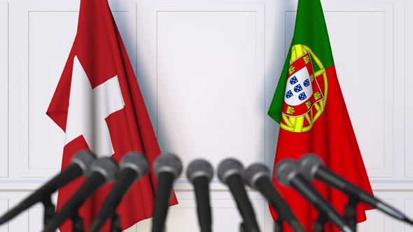 Flags of Switzerland and Portugal at International Press Conference alt