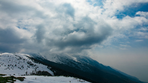 Mountains Peaks with Snow and Passing Clouds