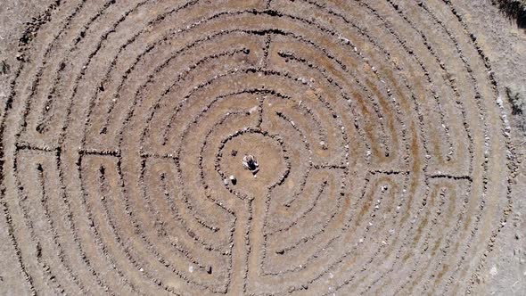 Aerial view flying up above labyrinth viewing the pattern from the sky