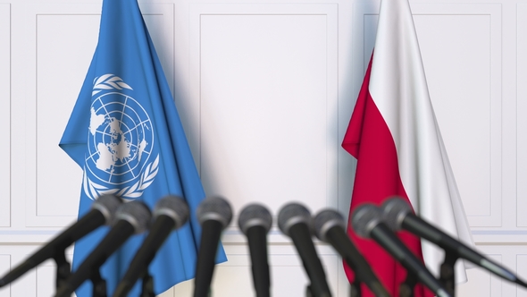 Flags of the United Nations and Poland at International Press Conference alt