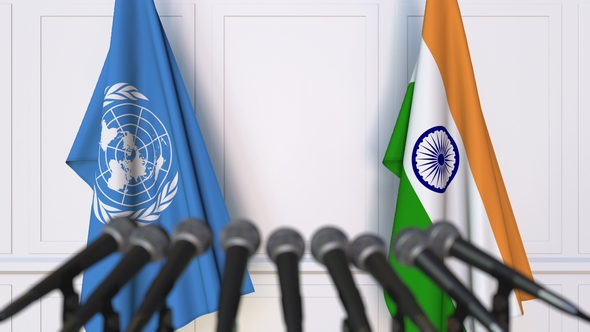 Flags of the United Nations and India at International Press Conference alt