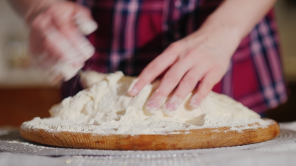 The Baker's Hands Knead the Pizza Dough. Video with Shallow Depth of Field