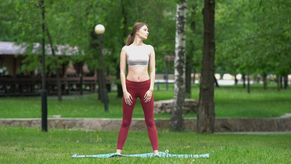 Young Sporty Girl Doing Yoga in the Park
