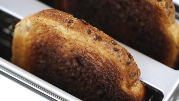 Burnt Toast Bread Smoking in White Toaster Machine