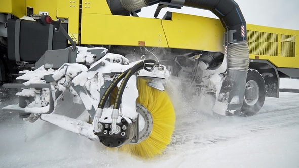 Heavy Wheel Machinery Removes Snow From the Road with Big Massive Rotating Brush in the Snowy