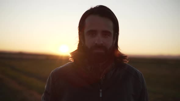 Man standing in middle of field and looking at camera