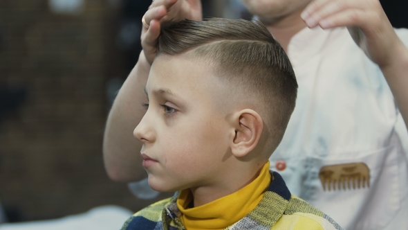 The Hairdresser Makes a Hairstyle for Her Little Client New Haircut for Boy Barbershop