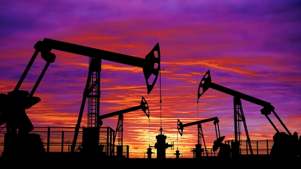 Looped Oil Pumpjacks Against Pink Sunset Sky