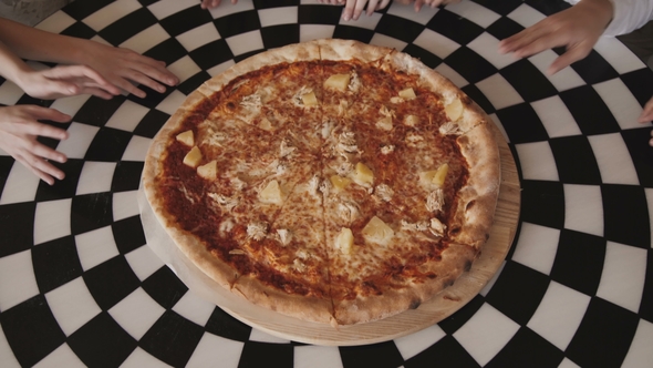 View of Children's Fingers Moving Synchronously and Fast to Pizza in a Centre