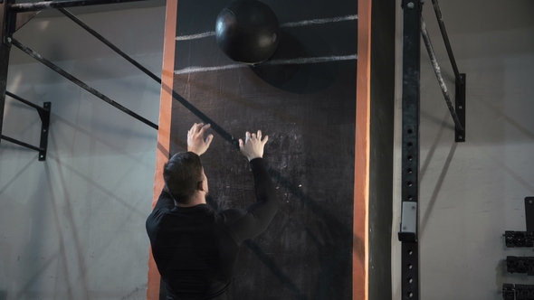 Man Training with Weight Ball