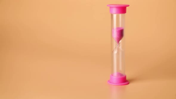 Pink Sand passes, running through hourglass bulbs measuring