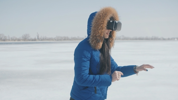 Portrait of Young Woman Blue Jacket Getting Experience in Using VR-headset Outdoor at Winter