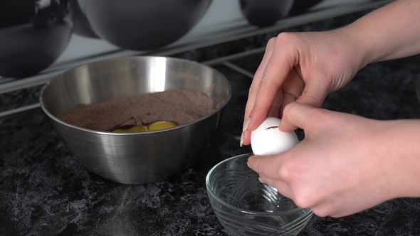 the Woman Breaks the Eggs and Separates the Proteins From the Yolks