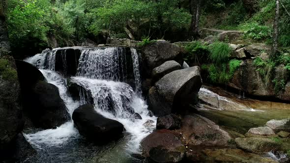 Waterfall surrounded by green nature and trees