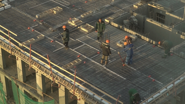 Workers Walk on the Construction Site