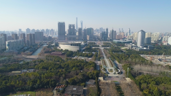 Green Park and Shanghai Downtown at Sunny Day. China. Aerial View. Drone Is Flying Forward and Up