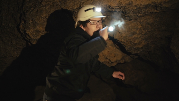 The Speleologist Finds and Goes in Passage in the Cave