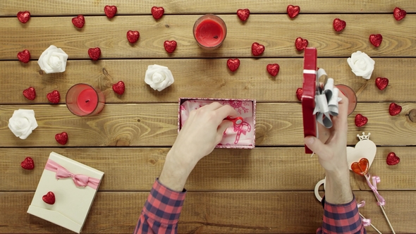 Man Puts Spinner Into the Gift Box As Holiday Present, Top View