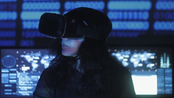Woman Hacker Programmer Uses a Virtual Reality Helmet for Programming. IT Technologies of the Future