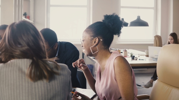 Multi Ethnic Business Partners at a Board Meeting. Young Mixed Race Colleagues Develop Company