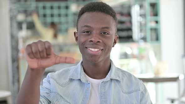 Disappointed African Man Doing Thumbs Down