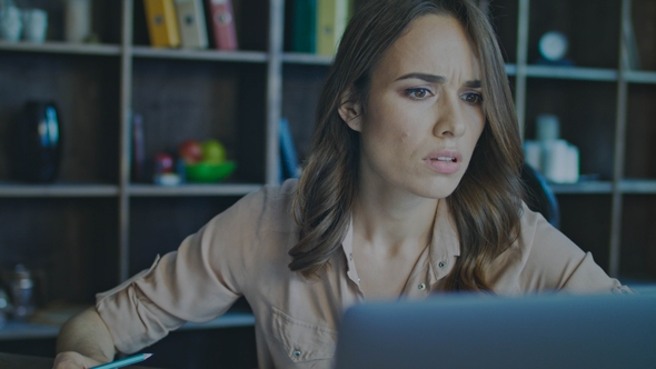 Upset Business Woman Working on Laptop in Office