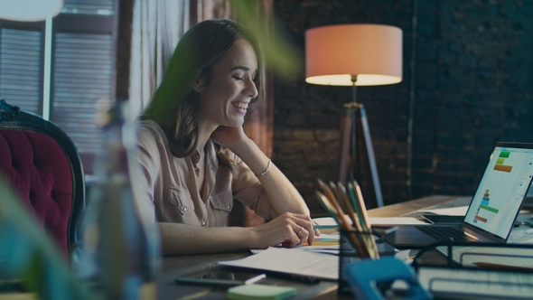 Happy Business Woman Reading Good News on Laptop Computer in Home Office