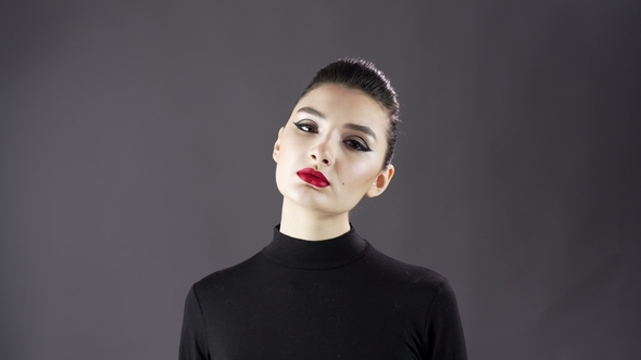 Portrait of a Beautiful Sexy Girl. Fashion Model Posing on a Dark Background for Studio Photo Shoot