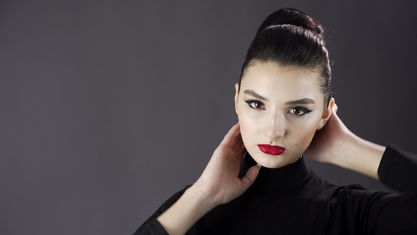 Portrait of a Beautiful Sexy Girl. Fashion Model Posing on a Dark Background for Studio Photo Shoot