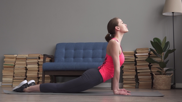 Happy Fitness Woman Doing Stretching and Relaxation Exercises on Floor