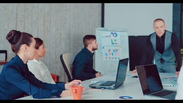 Executive Director Discusses the Company To His Employees in the Office