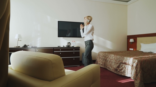 Blonde Businesswoman Talking on Phone Then Taking Her Suitcase and Leaving Hotel Room at Check-out