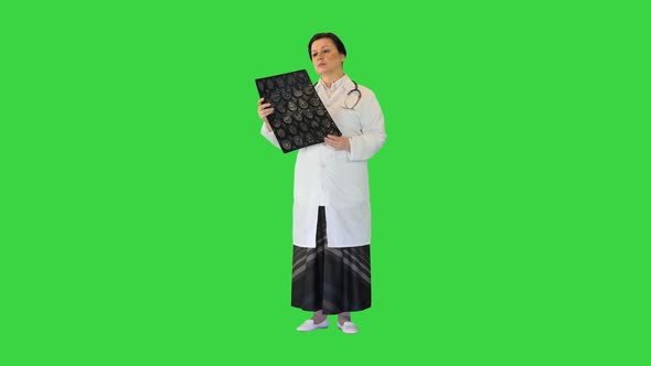 Senior Female Radiologist Examining Brain Scan Mri on a Green Screen Chroma Key