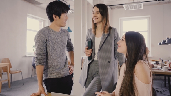 Camera Follows Female Leader Enter Office, Then Chat with Colleagues. Happy Multiethnic Business