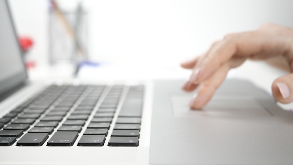 Woman Using Touchpad on a Laptop