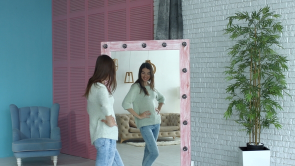 Joyful Woman Checking Her Body Shape in Mirror