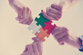 Group of business people assembling jigsaw puzzle - PhotoDune Item for Sale