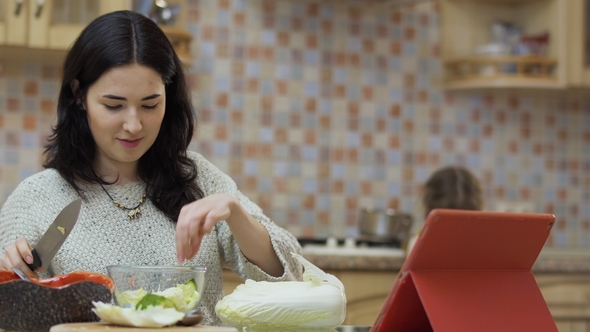 Little Girl Brings a Pan To Mother To Put Salad Inside It