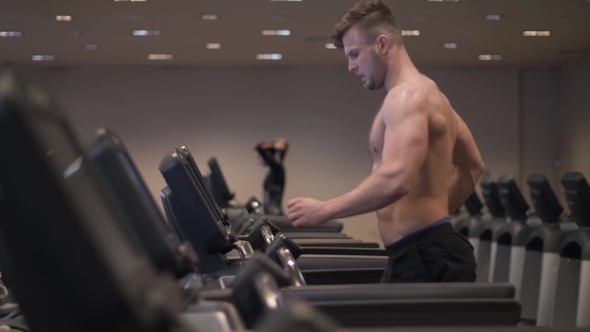 Man Using Screen Treadmill for Configuring Program Cardio Exercise and Running