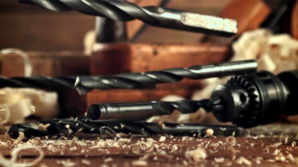 Drill Bits Fall on a Table of Sawdust