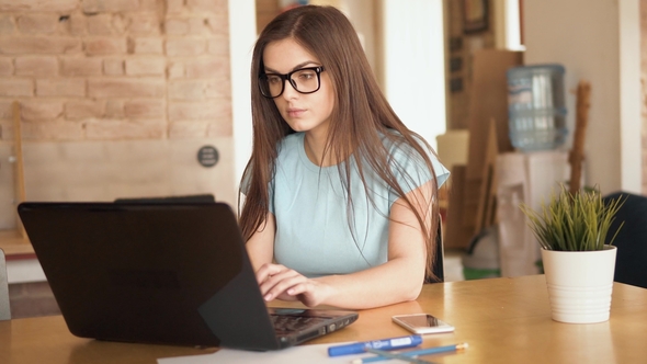 Woman Works at Laptop