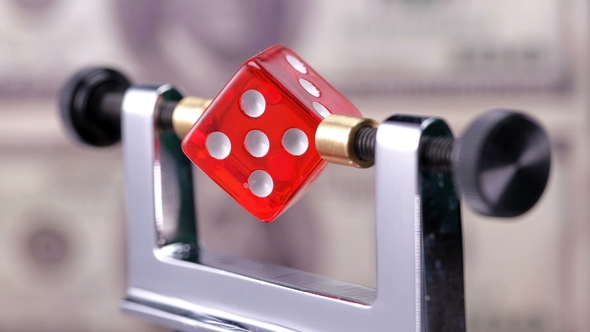 The Dice Are Spinning on the Balance Device so That the Game Is Fair